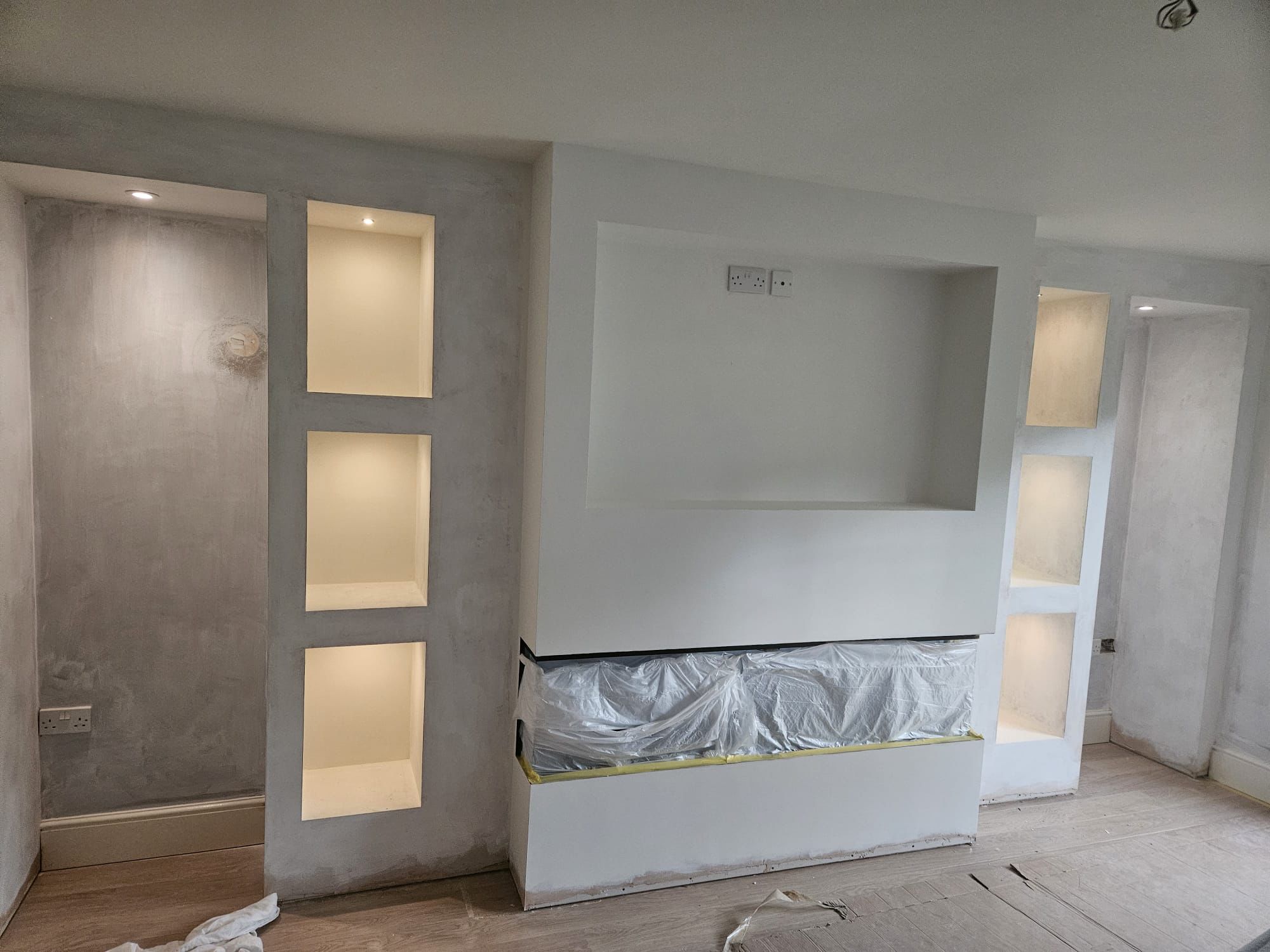 Freshly skimmed media wall with LED-lit display niches