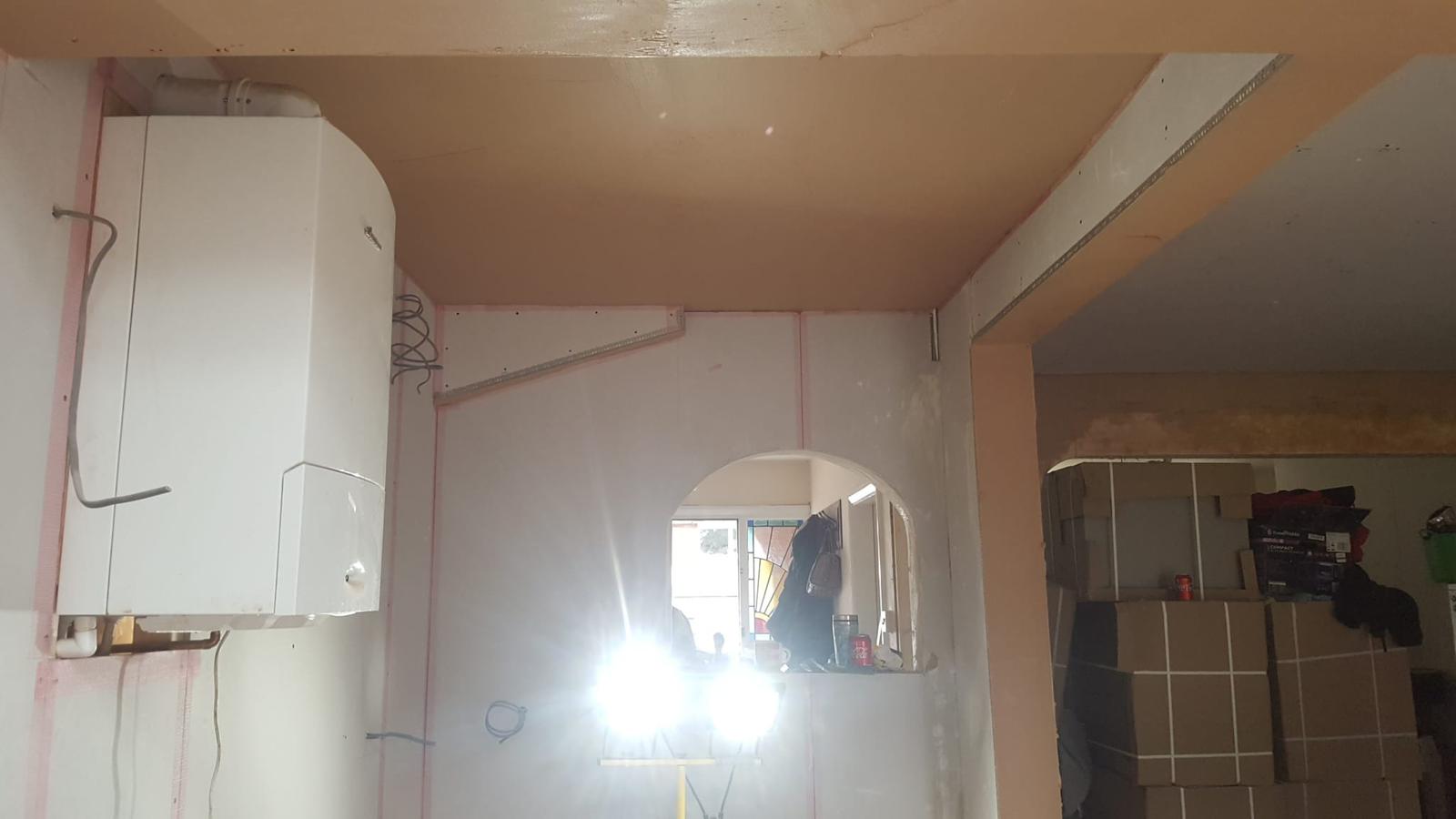 Kitchen area with boiler, archway and freshly plastered ceiling