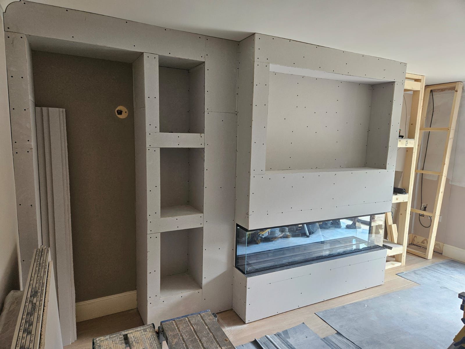Media wall fully plasterboarded with display niches, ready for taping