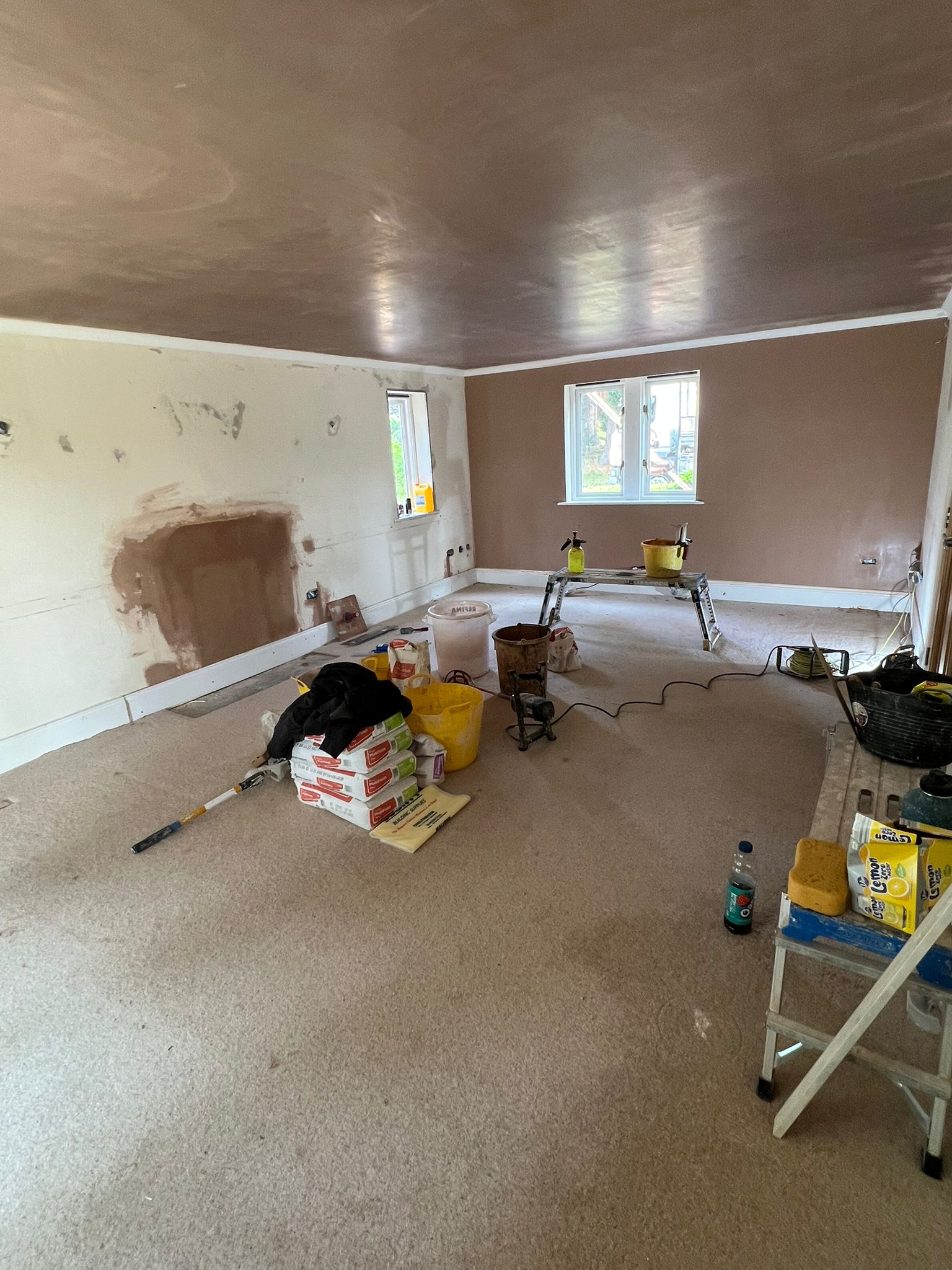 Large room being plastered — ceiling and walls