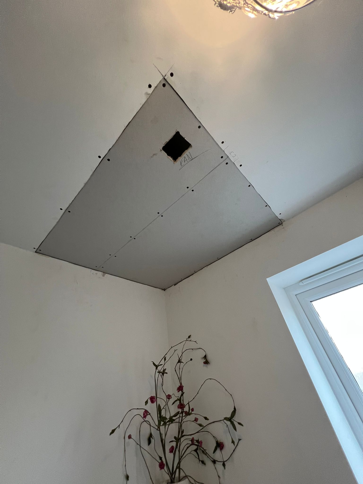 Ceiling plasterboard patch repair with extractor fan cutout