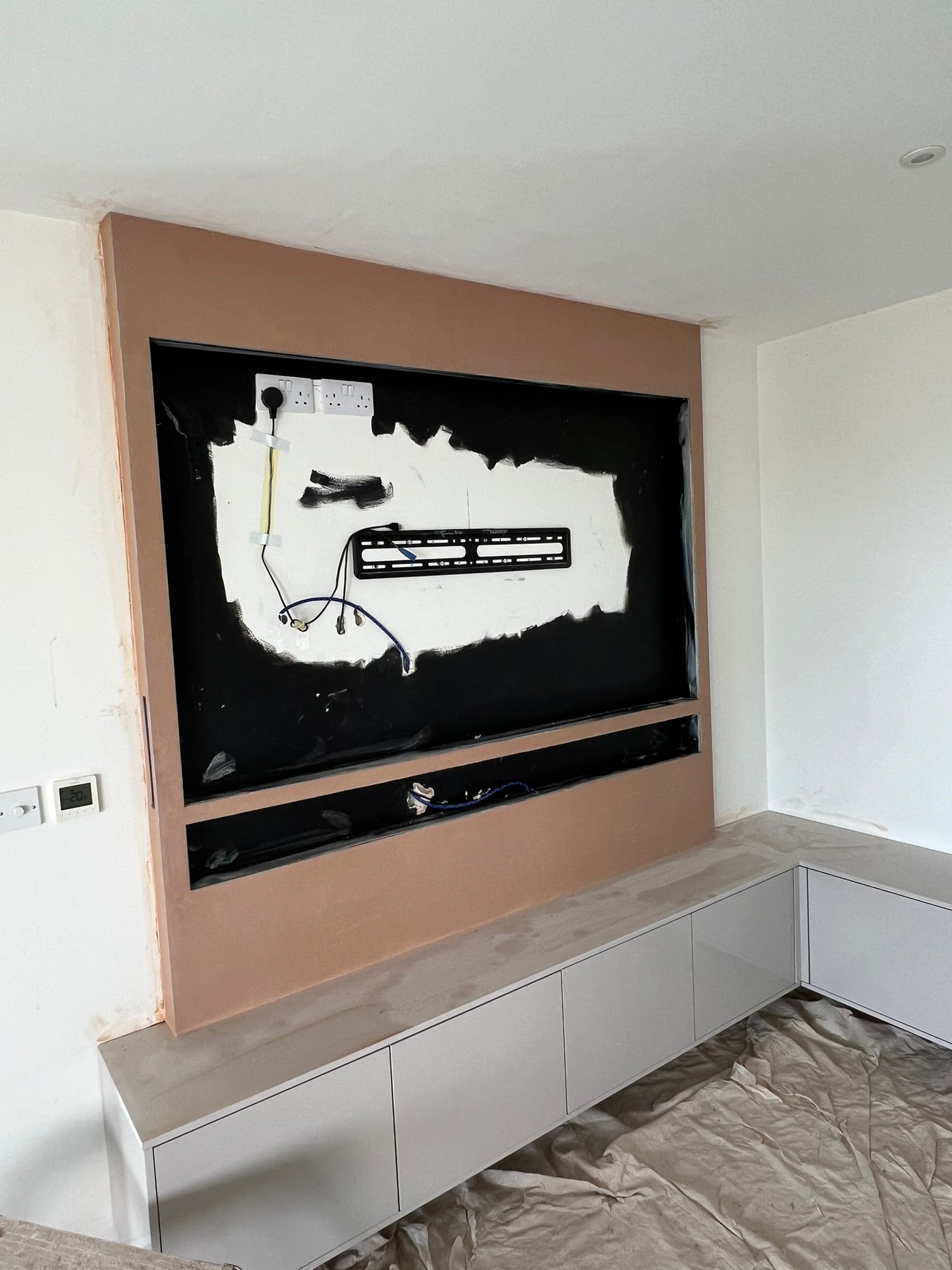 Media wall plastered surround with built-in storage unit