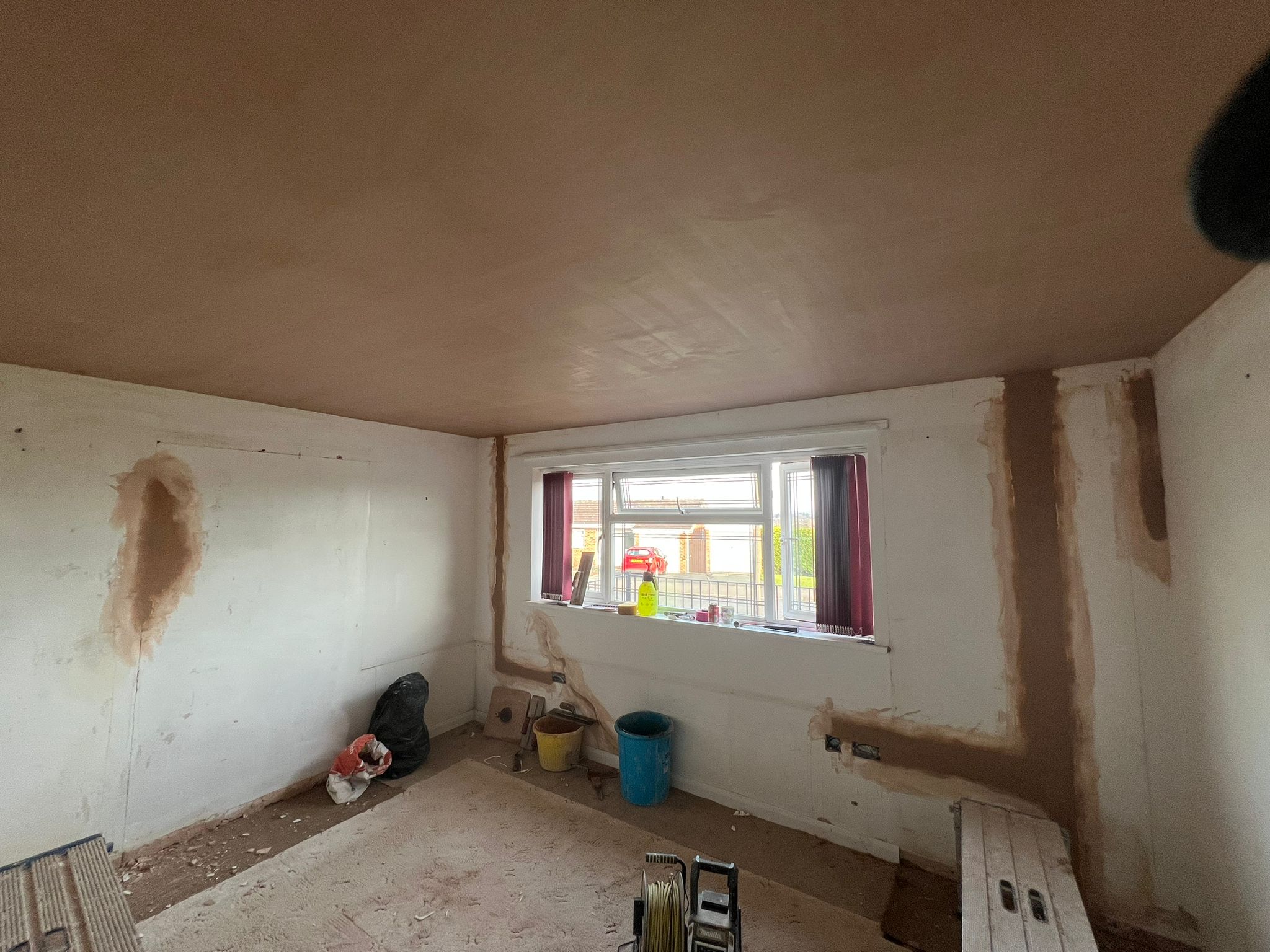 Bedroom ceiling freshly skimmed with walls being prepared
