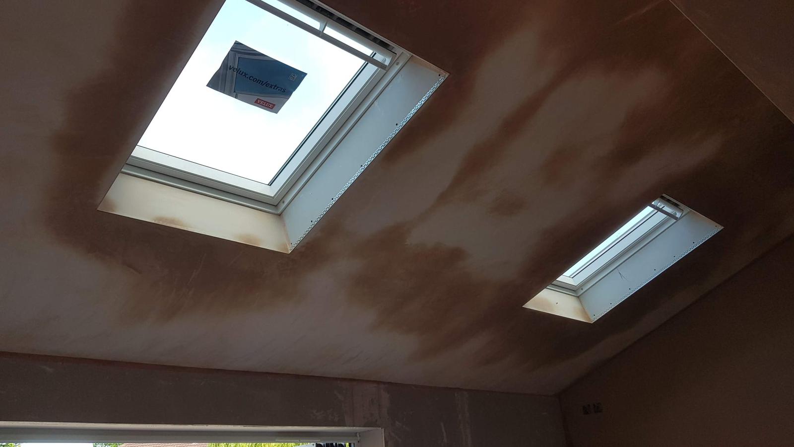 Freshly plastered ceiling with two Velux skylights