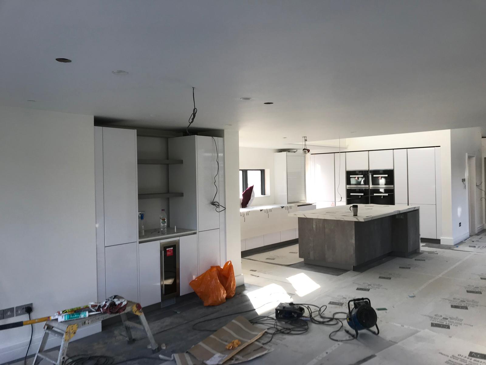 Open-plan kitchen and living area in new build, plastered throughout