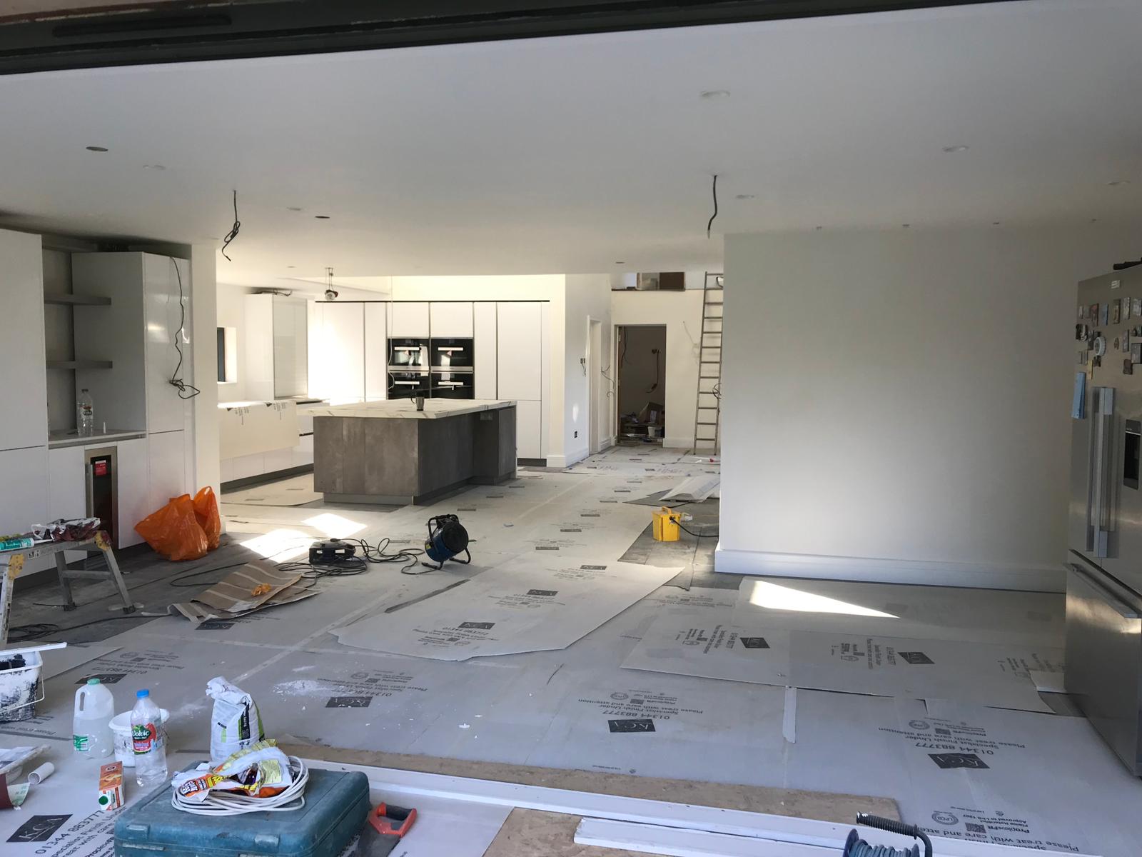 Wide angle of new build open-plan kitchen with bifold doors