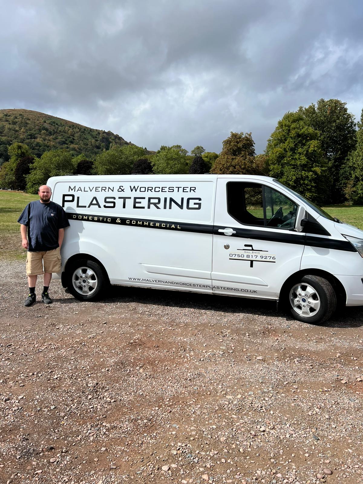 Steve Bell with his Malvern and Worcester Plastering van, Malvern Hills in the background